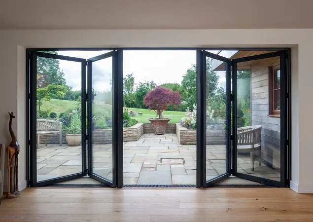 Makfold bi-fold doors opening to beautiful garden patio